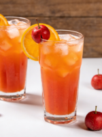 Suco de laranja com acerola gelado servido em copo de vidro com gelo e rodela de laranja